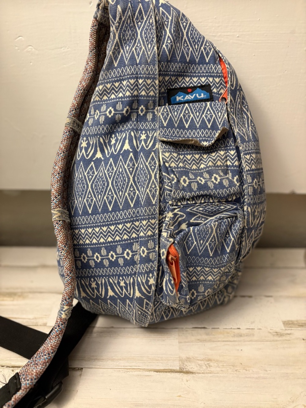 Kavu Blue and Cream Patterned Sling Backpack with Orange Accents